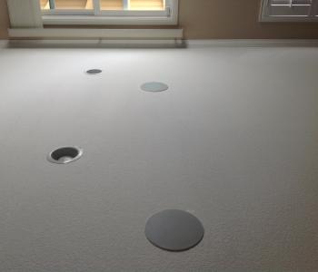 a photo of a ceiling with 2 integrated speaker systems installed in it